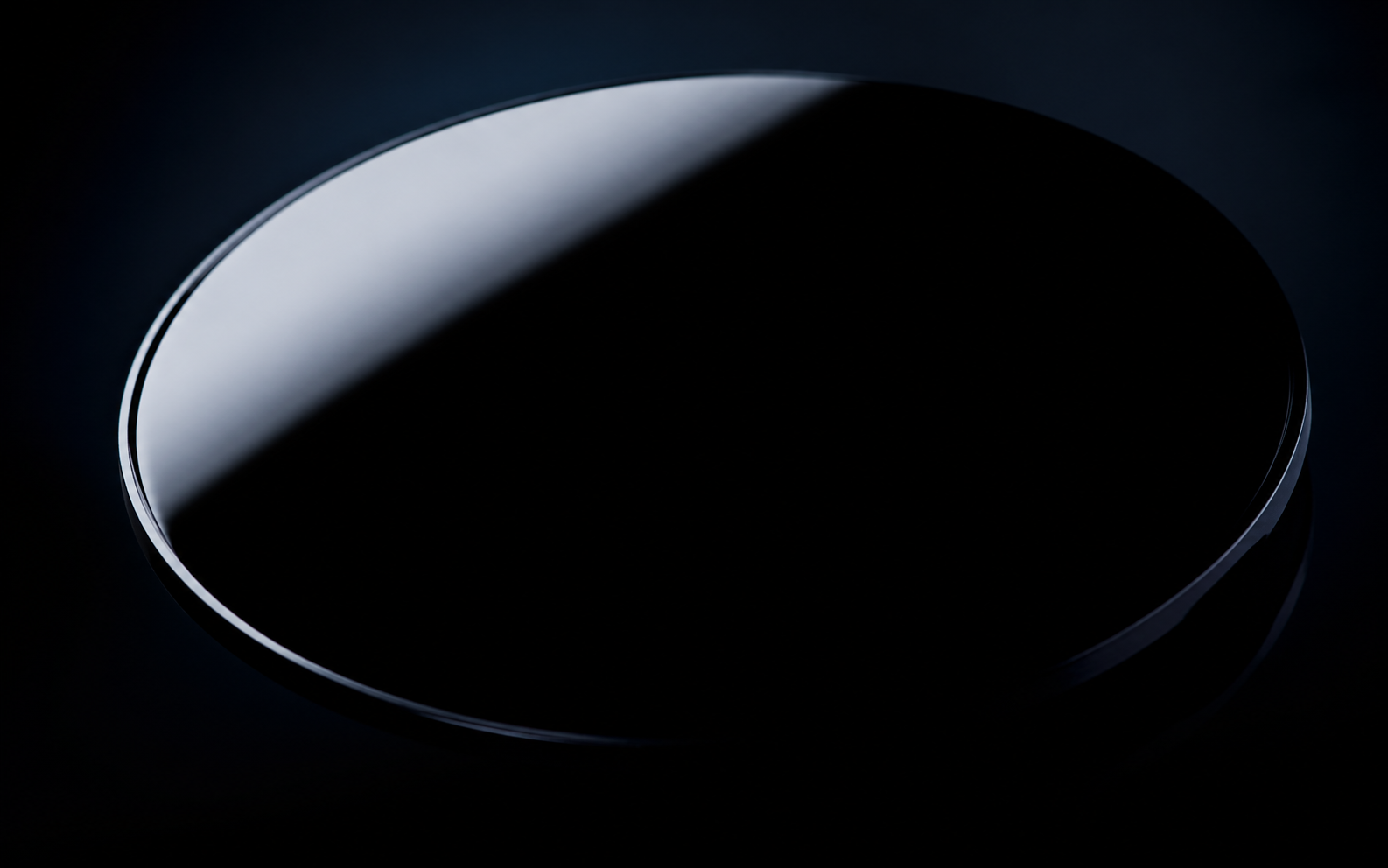 Close study of an ultra black enamel surface with a single glass-like highlight