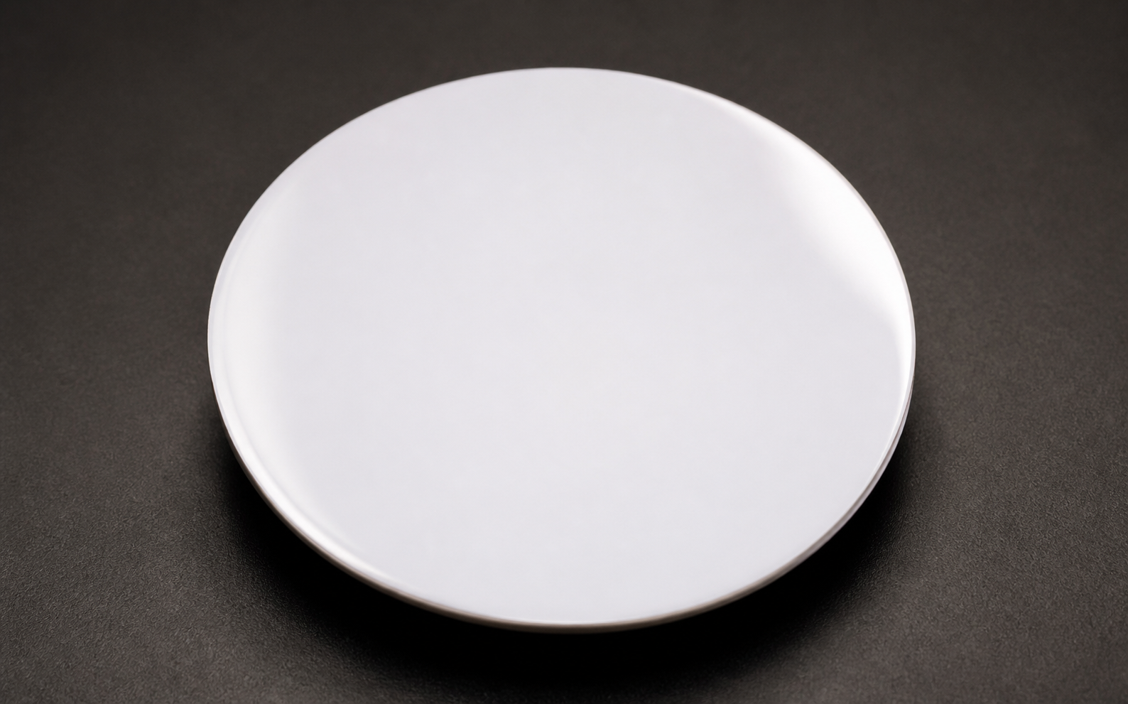 Blank white enamel dial blank before pad printing, with no hands, indices or artwork